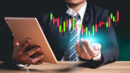 Man holding tablet with stock market chart, candlestick chart, stock trading and data analysis, presentation and digital media related to finance, technology and investment."