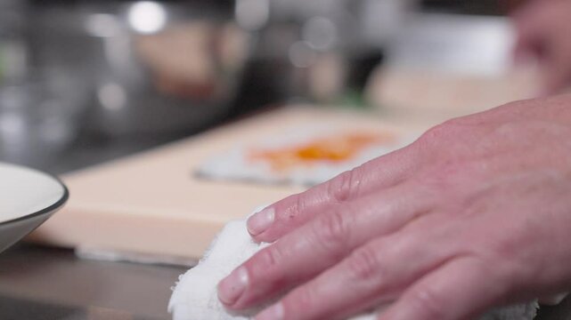 A roaming up-close shot captures a sushi roll being made, showcasing the detailed process of sushi preparation. Perfect for culinary, sushi-making, and professional kitchen content.