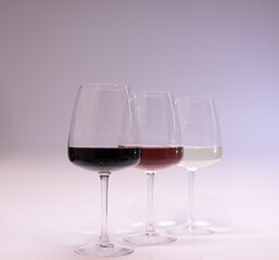 Red, white and rose wine glasses up. White background