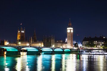 Naklejka premium Big Ben and Westminster Bridge Illuminated at Night With Reflections on the Thames