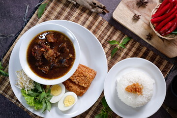 Rawon is an Indonesian beef soup. Originating from East Java, rawon utilizes the black keluak nut as the main seasoning, which gives a dark color and nutty flavor to the soup. Nasi Rawon, telur asin 1