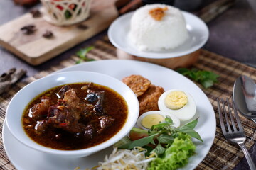 Rawon is an Indonesian beef soup. Originating from East Java, rawon utilizes the black keluak nut as the main seasoning, which gives a dark color and nutty flavor to the soup. Nasi Rawon, telur asin 3