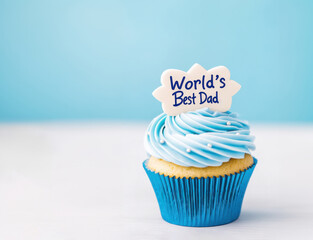 Father's day cupcake with blue frosting and gratitude topper. with copy space. Concept for father's day celebration, birthday, appreciation.