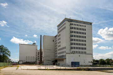 Decaying industrial architecture of a former flour mill at Deutzer Hafen, Cologne. Massive stone...