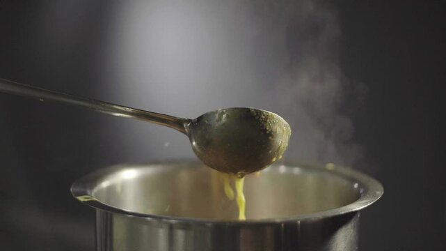Cooking yellow lentil at home. Cinematic Indian food shot.