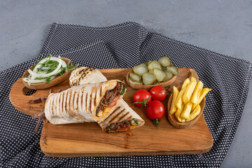 Meat Wrap Doner. Beef shawarma sandwich fresh roll, wrap of grilled meat and salad tortilla wrap with white sauce. turkish Doner Kebab on a lavash.