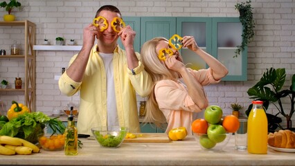 Couple of man and woman in the morning at home in the kitchen at table preparing breakfast, man...
