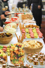 catering buffet with variety of food snacks and appetizers.