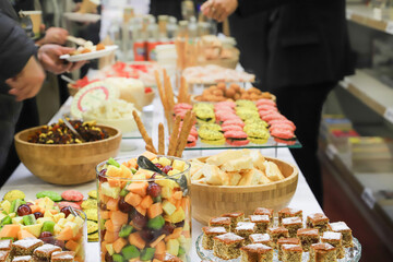 catering buffet with variety of food snacks and appetizers.