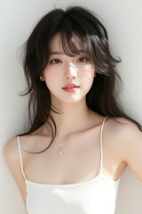 Asian Female in Studio Setting - Young Woman on White Background with Soft Shadows - Styled Long Hair - Portrait of Eastern Beauty for Fashion or Cosmetic Model - Photoshoot Modelling
