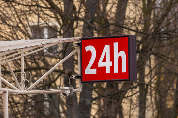 Red illuminated sign with the inscription 24, 24-hour alcohol store, open 24 hours a day,
