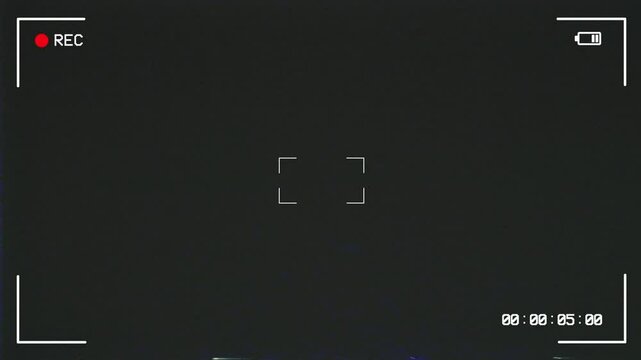 Camera screen recording with VHS glitch effect displaying information about battery status, playback, timer status. Camcorder interface with vintage noise dust effect. Videotape recording.