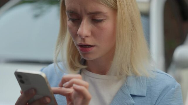 Stressed frustrated Caucasian female client businesswoman scroll mobile phone automobile car rent app in city woman shock negative news difficulty driver girl reading bad message social media online