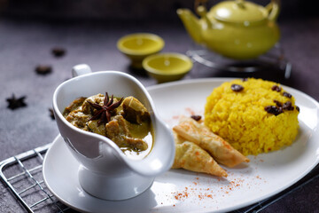 Chicken opor and rice complete with seasonings are served at the table 1