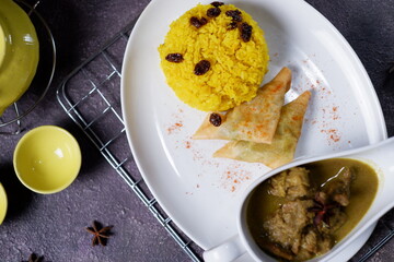 Chicken opor and rice complete with seasonings are served at the table 2