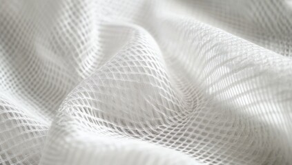 White mesh fabric with subtle texture and soft folds, showcasing intricate patterns and light reflections for artistic or fashion design applications