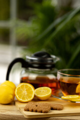Glass cup of tea, teapot, sliced lemons on the table. Kettle with tea. Lemon tea