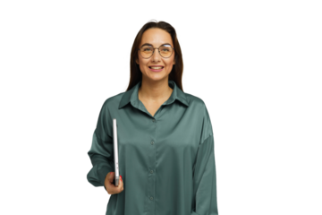 Smiling woman wearing a green shirt holds a notebook, exuding confidence and positivity in a neutral space