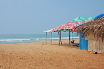 Colorful beach shack or kiosk or beach cafe on the quiet empty sandy beach Calagunte of Goa, India