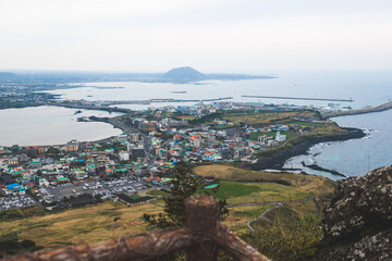 Fototapeta premium Jeju-do, Seongsan Ilchulbong landscape, volcanic tuff cone, Sunrise peak, Jeju Island, South Korea, Seongsan-ri, Seogwipo, Jeju Province landscape view in a sunny day, with sea, cliffs hiking trail