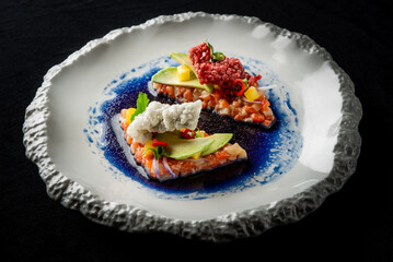 Elegant gourmet dish featuring beautifully arranged sushi with fresh ingredients, served on a textured plate. A vibrant and artistic presentation that emphasizes modern culinary trends.