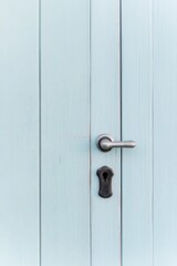 Fototapeta premium close-up of vintage door handle on half-restored wooden door showing contrast between aged patina and freshly painted