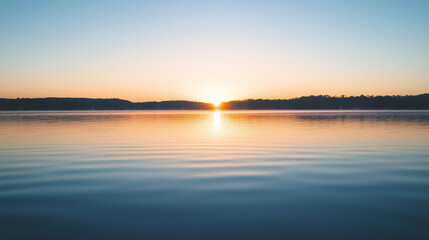 Tranquil sunrise over a calm lake, evoking peace and serenity.