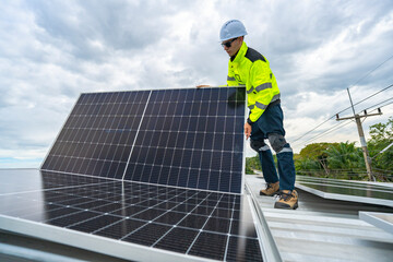 A skilled technician adjusts a solar panel on rooftop, emphasizing the transition to sustainable energy. Equipped with safety gear, the worker demonstrates precision in renewable energy installations.
