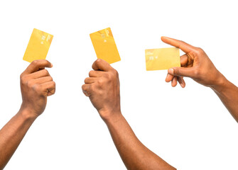 Three hands holding gold-colored debit cards against a black background. Two hands grip the cards firmly, while one holds it delicately. The image emphasizes finance, transactions, and modern banking.