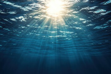 Fototapeta premium Sunlit water surface with rays penetrating through ocean depths showcasing a serene underwater world