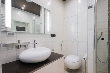 Faucet with ceramic sink and mirror in the bathroom