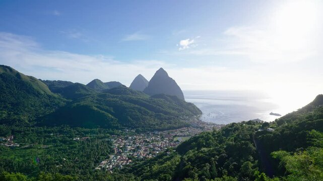 An elevated view of the small town of Soufriere in St Lucia with the twin Pitons in the background. 4k static video.