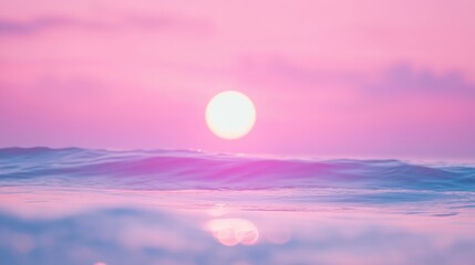 Fototapeta premium A serene sunset casting pink hues over gentle ocean waves.