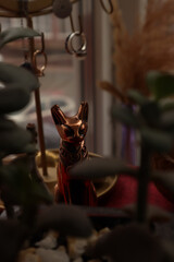 Close-up of a copper figurine of an Egyptian cat.