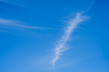 cirrus clouds in the center of the image on a blue sky