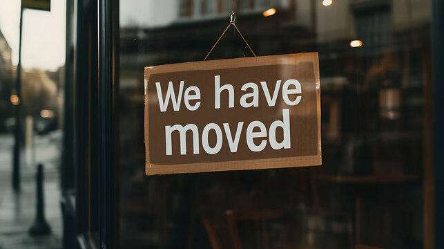 Closed business notice: A storefront announces "We have moved", signaling a change in location or shutdown, impacting local commerce. The message is clear and direct.