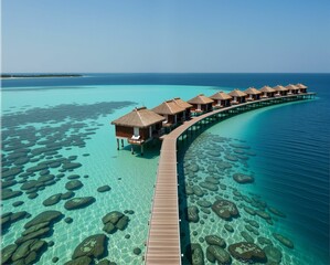 Fototapeta premium A picturesque overwater bungalow resort surrounded by clear turquoise waters and coral reefs, showcasing a serene tropical paradise.