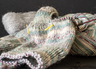 knitted socks made of wool yarn, handicraft concept, knit