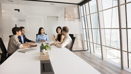 Workforce briefing. Busy multiethnic corporate department staff meet on workshop seminar at modern...