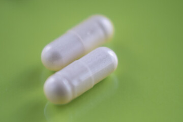 pills and bottle. A medicine, solid dosage of a medicine, usually a tablet, The medicine is small and solid.