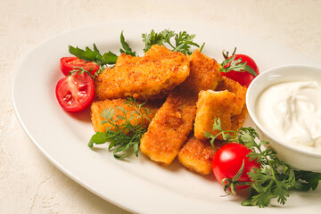 fried fish nuggets, with white sauce, arugula and cherry, no people,