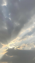 Cloudy sky with sunbeams, outdoor view, nature scene, perfect for backgrounds