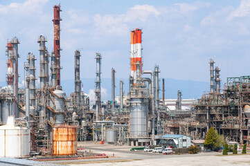Industrial factory landscape with towering structures and clear blue sky in daytime