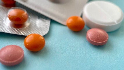 Close-Up of Pharmaceutical Pills and Blister Packs on Blue Background