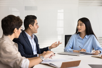 Formal business discussion. Serious mature businessman speak to diverse multicultural corporate partners colleagues at negotiation table offer expertise present growth strategy explain point of view