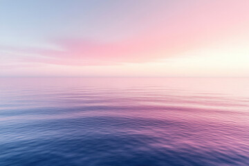 Obraz premium Serene pink and purple sunset reflecting on calm ocean water.