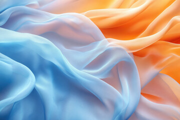 Fototapeta premium Soft, flowing fabric in shades of blue and orange, creating a dreamy, abstract texture.