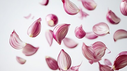 Whole and sliced shallots hovering mid-air, emphasizing their delicate layers and rich purple hue on a white background.