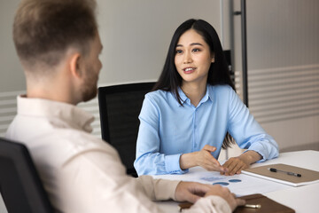 Data analysis at workplace. Young Asian businesswoman office employee discuss business documents...