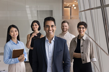 About us. Successful mature businessman corporate top manager bank department director stand in front of diverse ambitious business experts team proud of leading international professional workforce